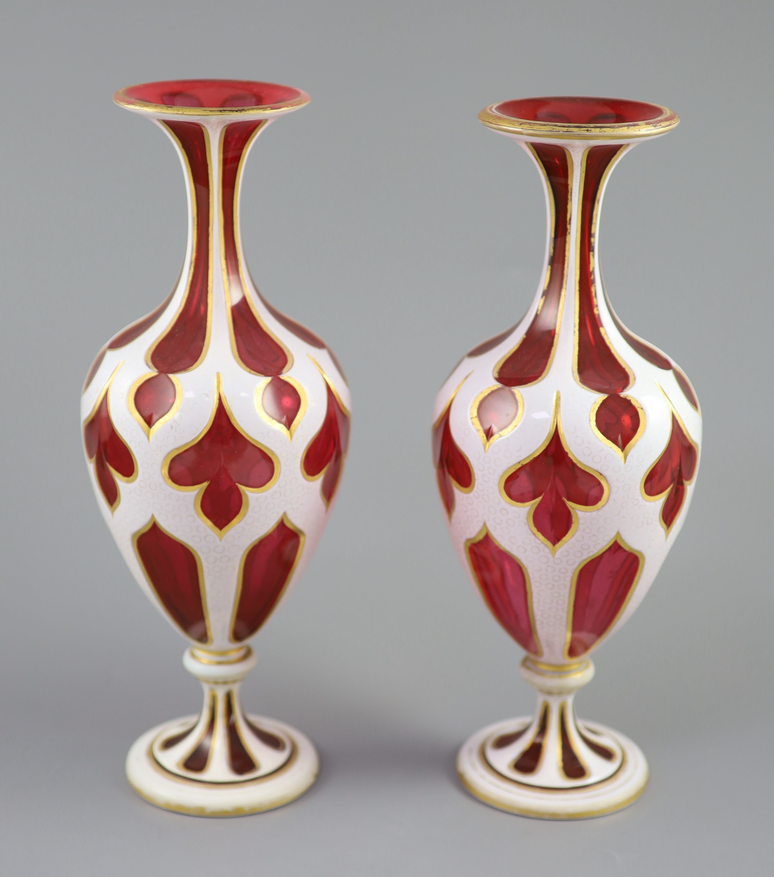 A pair of Bohemian white and ruby overlaid glass vases, 31cm high